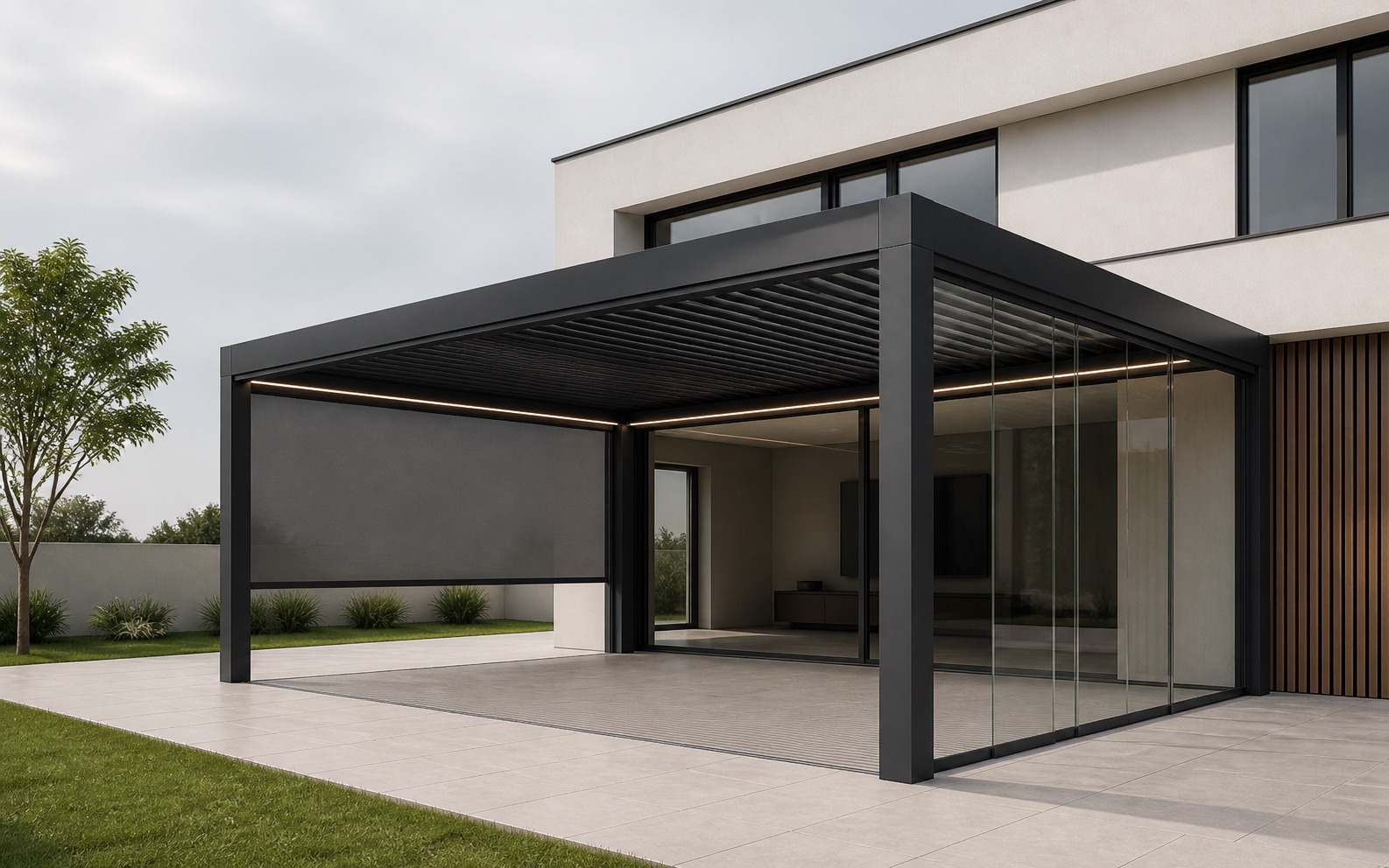 Wall-mounted anthracite bioclimatic pergola with rotating louvers, a zip screen, sliding glass and integrated lighting
